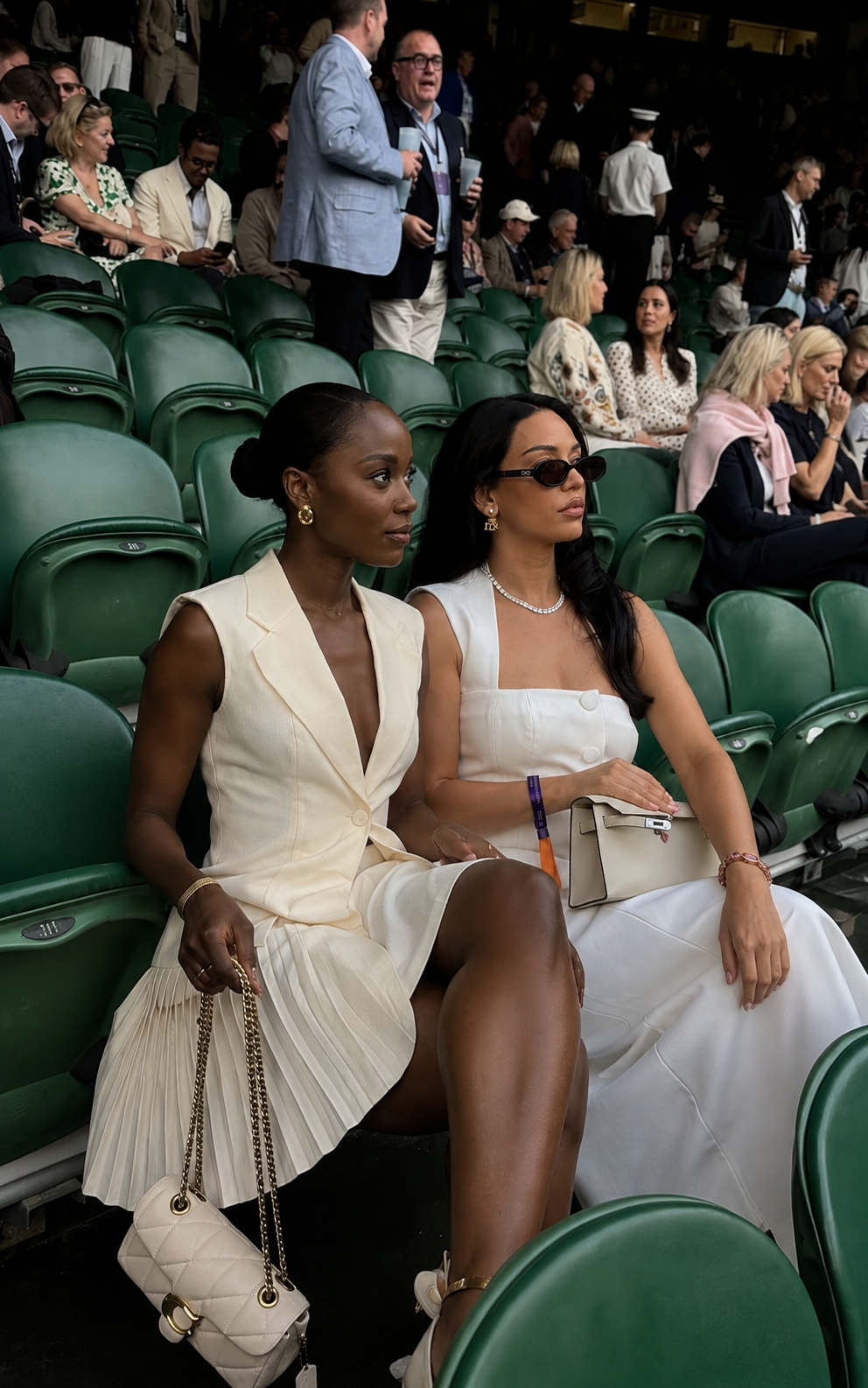 Two members seated in a private tennis suite